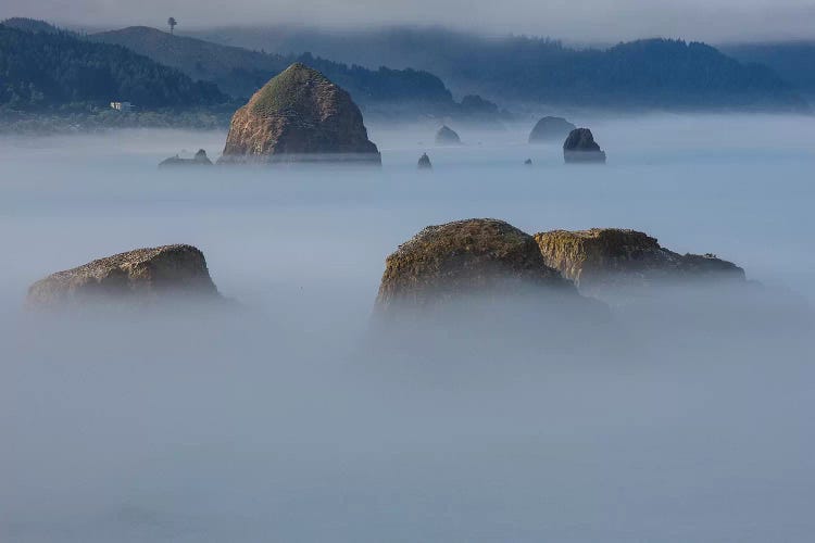 View of Cannon Beach with sea stacks with rising fog from Ecola State Park