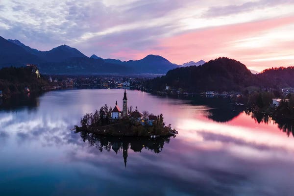 Cloudy Sunsets: First Light On Bled Lake, Slovenia by Matteo Colombo
