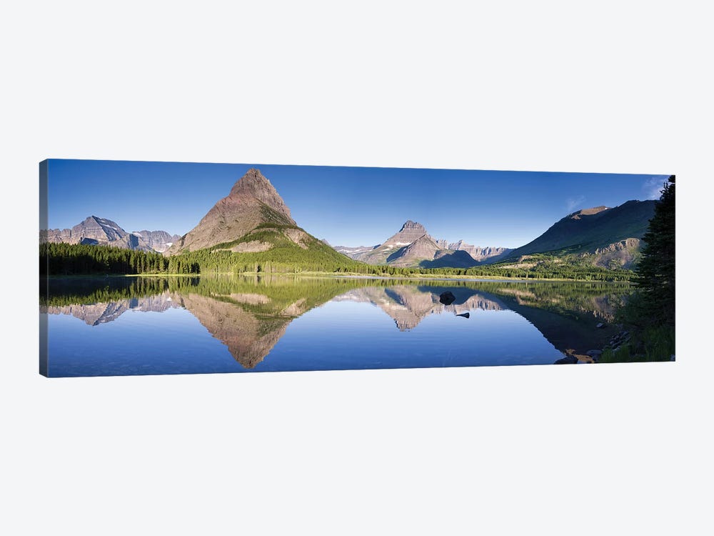 Mountains reflected in lake. Glacier National Park. Montana. Usa. by Tom Norring 1-piece Canvas Print