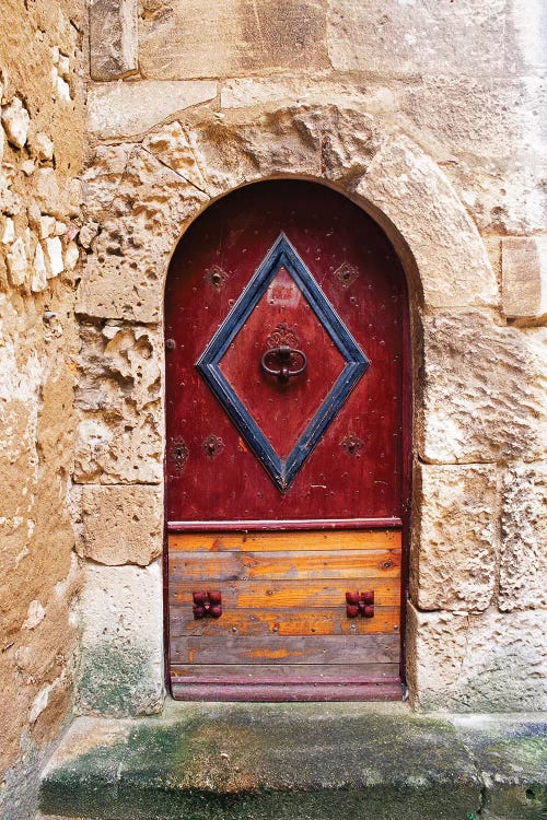 Colorful door in the stone wall of a chateau in France.