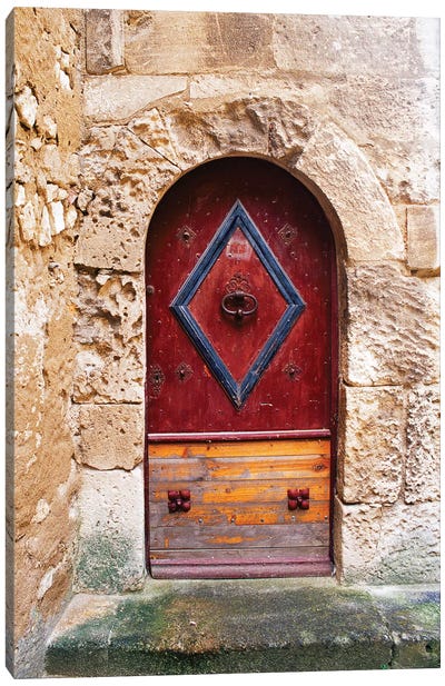 Colorful door in the stone wall of a chateau in France. Canvas Art Print
