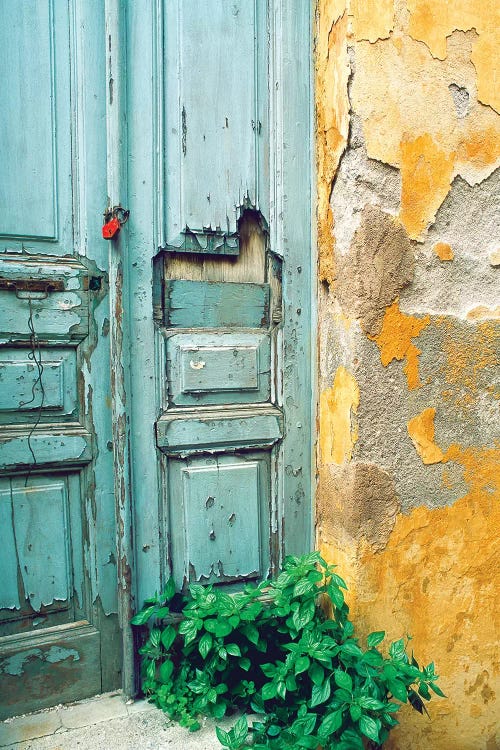 Red lock on a weathered blue door.