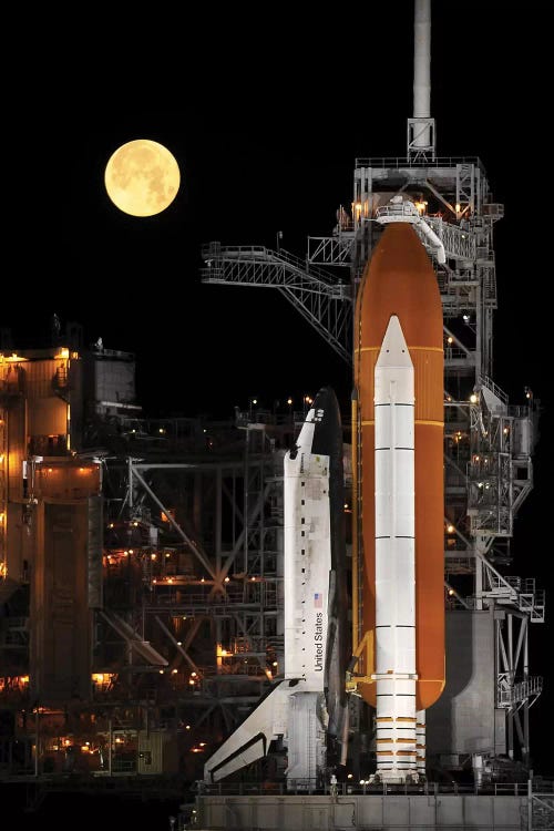 A Nearly Full Moon Sets As Space Shuttle Discovery Sits Atop The Launch Pad