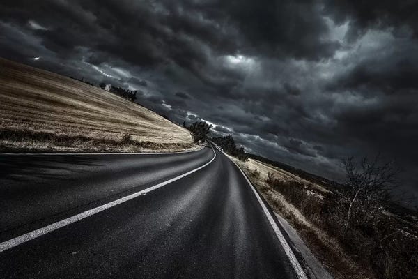 Evgeny Kuklev: A Curved Asphalt Road With Stormy Sky Above, Tuscany, Italy. by Evgeny Kuklev