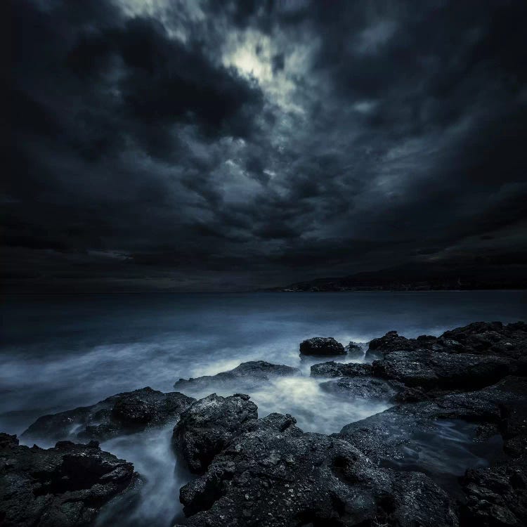 Black Rocks Protruding Through Rough Seas With Stormy Clouds, Crete, Greece.