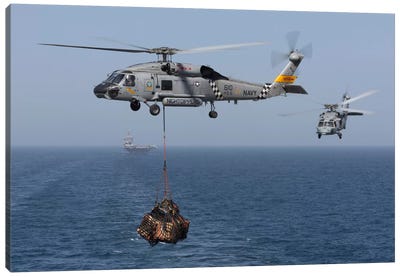 A SH-60J Seahawk Transfers Cargo During A Vertical Replenishment Canvas Art Print