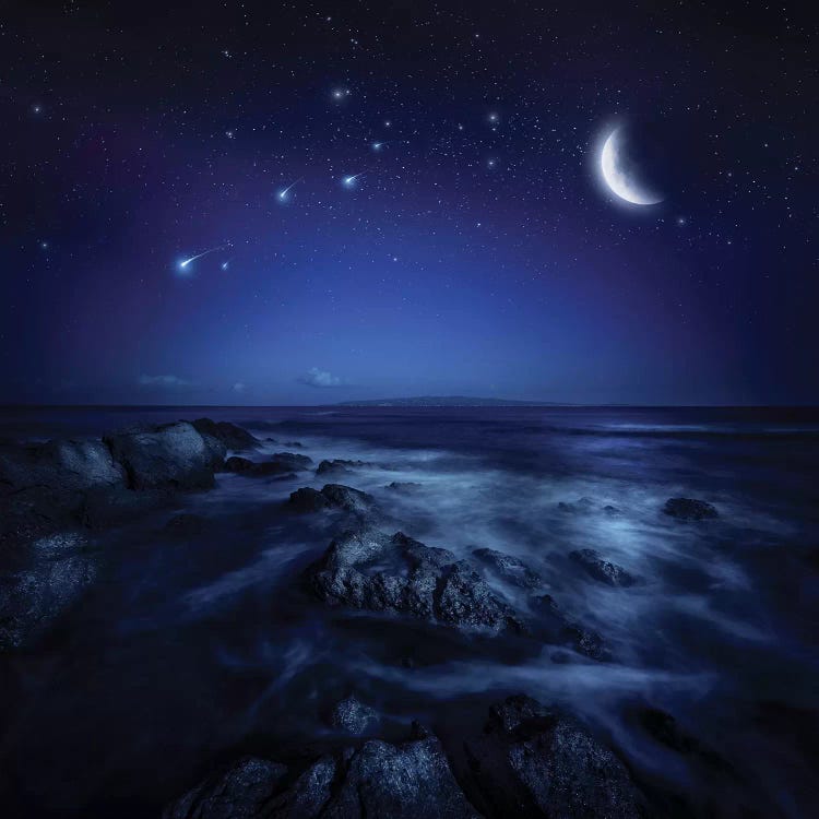 Rising Moon Over Ocean And Boulders Against Starry Sky.