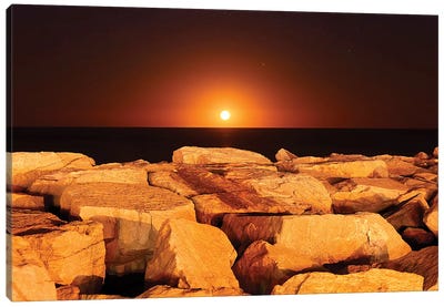 The Moon Rising Behind Rocks Lit By A Nearby Fire In Miramar, Argentina Canvas Art Print