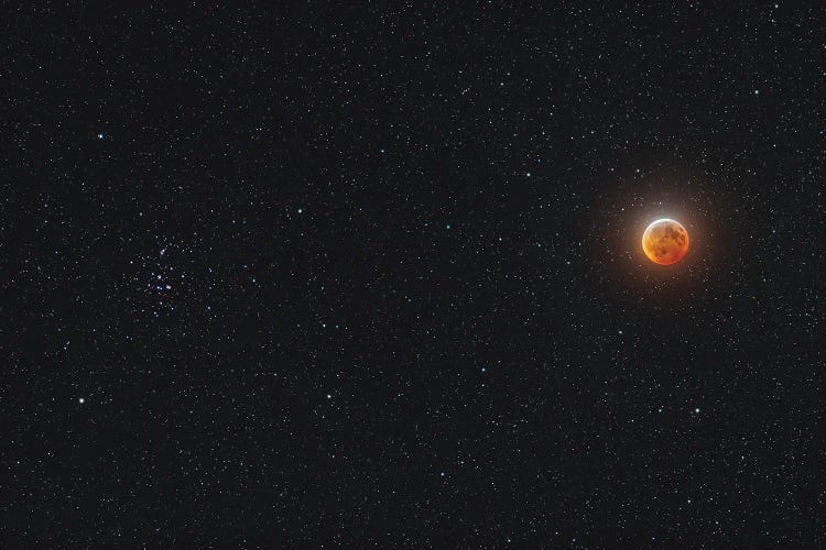 Eclipsed Moon Beside The Beehive Star Cluster.