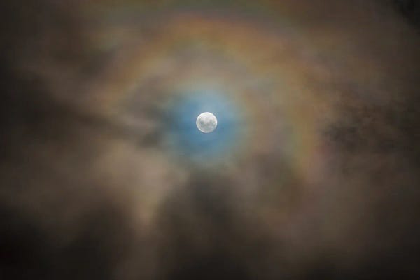 Full Moon And Lunar Corona Amongst Fast-Moving Low Clouds.