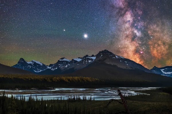 Stargazers: Milky Way, Jupiter And Saturn Over The Saskatchewan River And Mount Chephren, Canada. by Alan Dyer