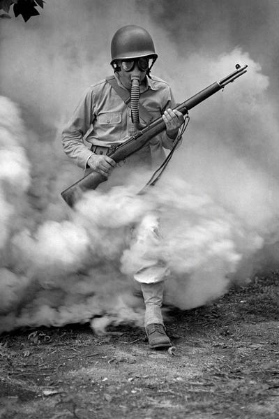 Vernon Lewis Gallery: Soldier With Rifle During Gas Mask Training At Fort Belvoir, Virginia, During World War II, 1942 by Vernon Lewis Gallery