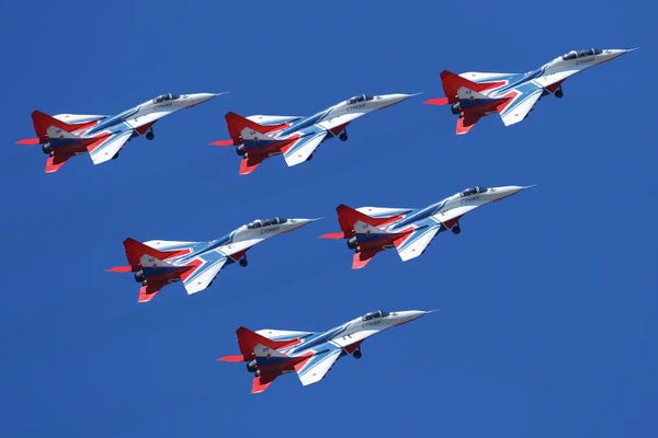 All Purples: Mig-29 Jet Fighters Of Strizhi (Swifts) Aerobatics Team Of The Russian Air Force Fly In Formation by Artem Alexandrovich
