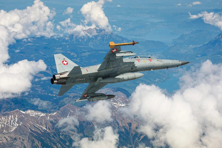 A Swiss Air Force F-5F Tiger II Flying Over The Outskirts Of The Swiss Alps