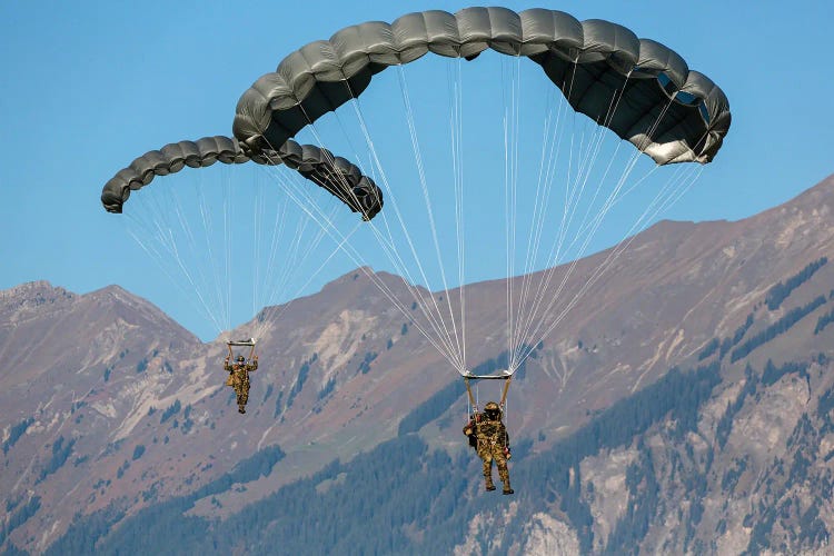 Swiss Army Paratroopers Descending Through The Sky, Meiringen, Switzerland