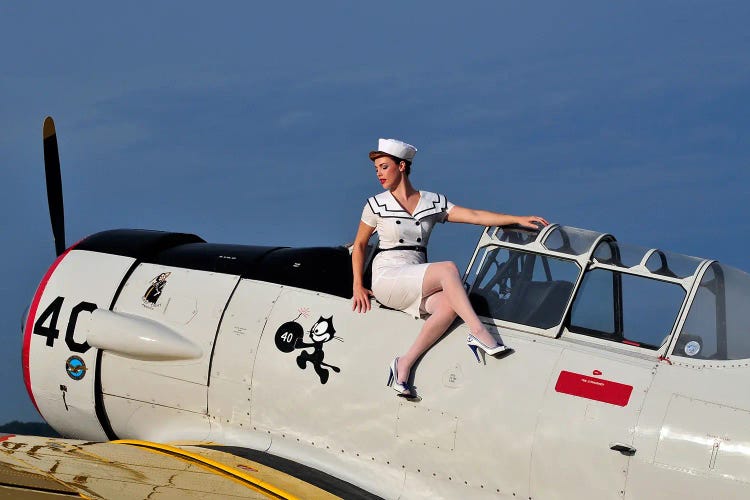 Navy Girl Sitting Near The Cockpit Of An SNJ Trainer Aircraft