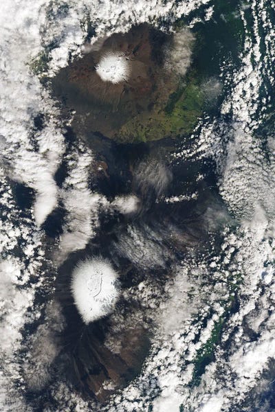 Snow On The Peaks Of Mauna Kea And Mauna Loa, Hawaii, From A Low-Pressure Kona Storm by Stocktrek Images canvas print
