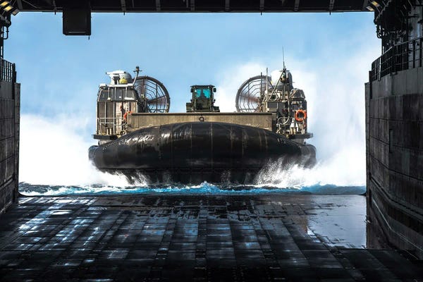 A Landing Craft Air Cushion Approaches The Well Deck Of USS Green Bay