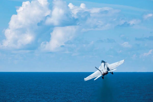 Military Aircraft: An F/A-18F Super Hornet Launches From The Aircraft Carrier USS George HW Bush by Stocktrek Images