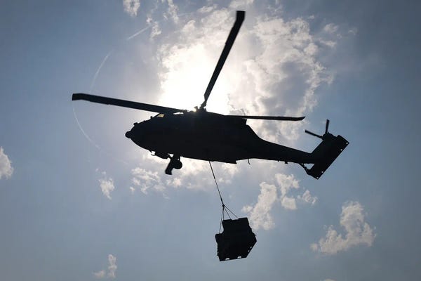 Military Aircraft: An Mh-60S Sea Hawk Helicopter Delivers Supplies During A Replenishment At Sea by Stocktrek Images