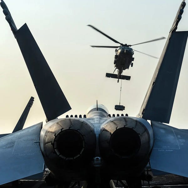 Military Aircraft: An Mh-60S Sea Hawk Helicopter Prepares To Deliver Ordnance To USS Nimitz by Stocktrek Images