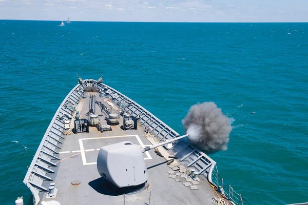 Warships: Guided-Missile Cruiser USS Hue City Fires Its Mark 86 5-Inch Gun In The Black Sea by Stocktrek Images