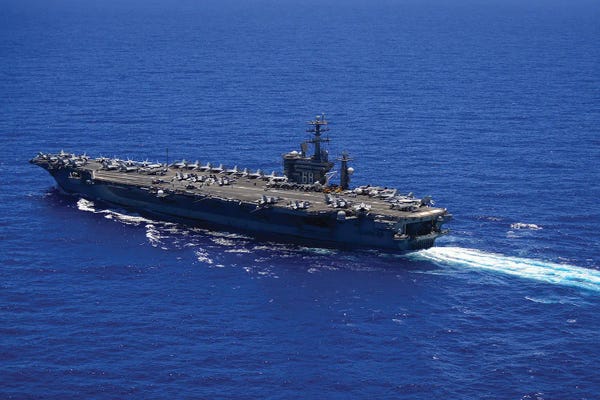 Warships: The Aircraft Carrier USS Nimitz Transits The Pacific Ocean by Stocktrek Images