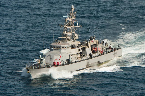 Warships: The Coastal Patrol Ship USS Firebolt Transits The Arabian Gulf by Stocktrek Images