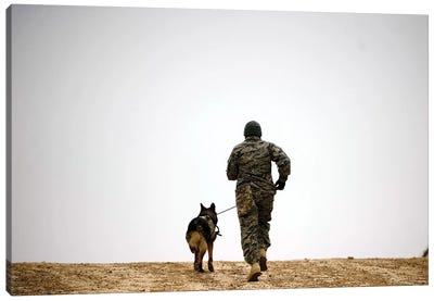 A Dog Handler And His Military Working Dog Take A Brisk Walk Canvas Art Print - Army Art