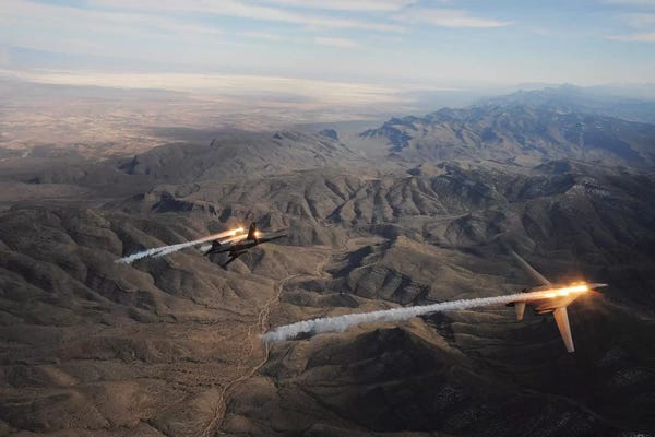 Military Aircraft: A Two-Ship Of B-1B Lancers Release Chaff And Flares While Maneuvering Over New Mexico by Stocktrek Images