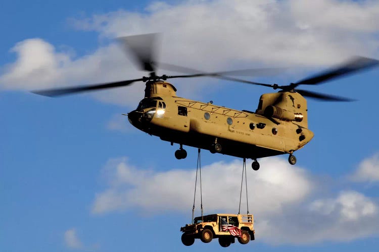 A US Army CH-47 Chinook Helicopter Transports A Humvee