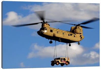 A US Army CH-47 Chinook Helicopter Transports A Humvee Canvas Art Print