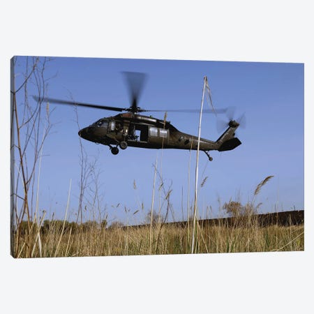 A US Army UH-60 Black Hawk Helicopter Prepares To Pick Up Soldiers Canvas Print #TRK631} by Stocktrek Images Canvas Wall Art