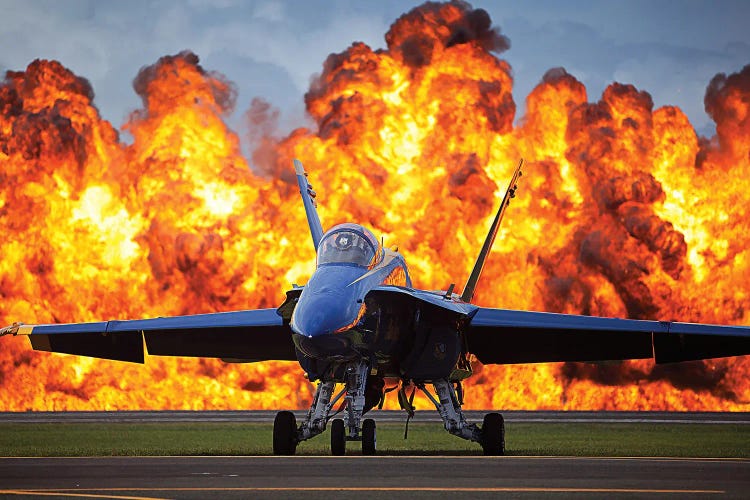 A Wall Of Fire Erupts Behind A US Navy F/A-18 Hornet Aircraft