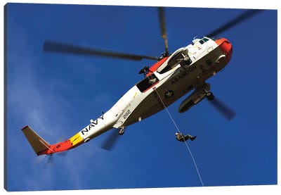 Airman Practices Rappelling Out Of A UH-3H Helicopter Canvas Art Print - Helicopter Art