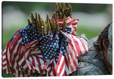 An Army Soldier's Backpack Overflows With Small American Flags Canvas Art Print - Stocktrek Images