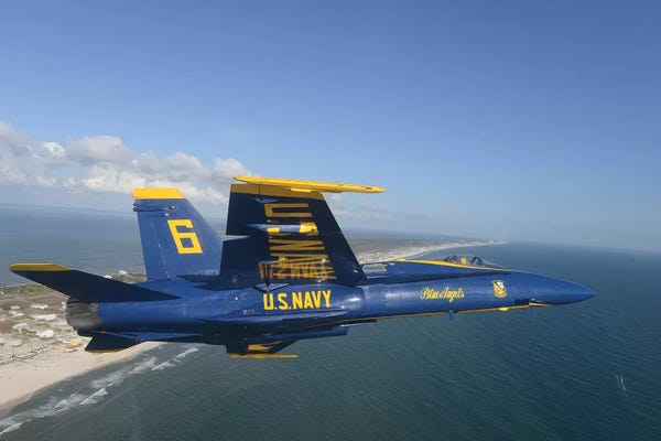 Military Aircraft: An F/A-18 Hornet From The Blue Angels Flies A Training Sortie by Stocktrek Images