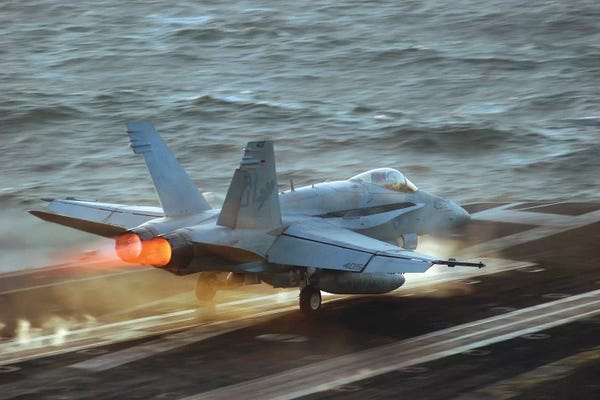 Stocktrek Images: An F/A-18C Hornet Launches From The Flight Deck Of USS Theodore Roosevelt by Stocktrek Images