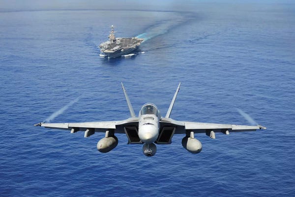 By Air: An F/A-18E Super Hornet Flying Above USS John C. Stennis by Stocktrek Images