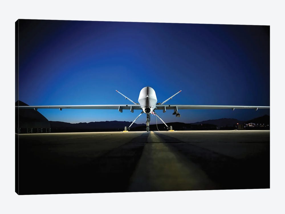 An MQ-9 Reaper Sits On The Flight line by Stocktrek Images 1-piece Canvas Print