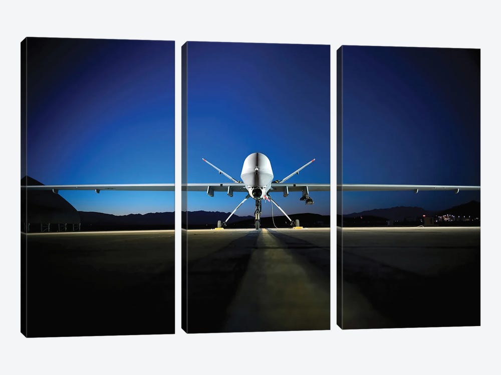 An MQ-9 Reaper Sits On The Flight line by Stocktrek Images 3-piece Canvas Art Print