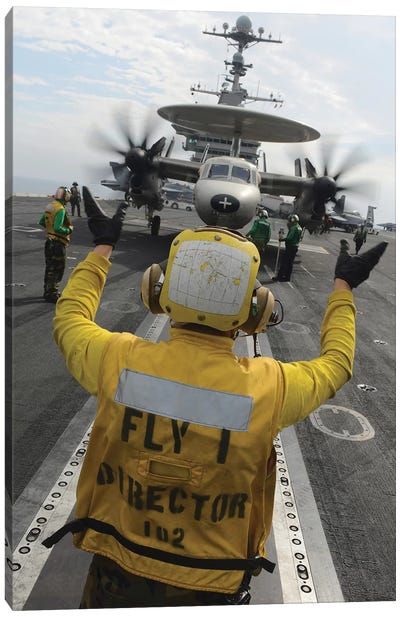 Aviation Boatswain's Mate Directs An E-2C Hawkeye Aboard USS John C. Stennis Canvas Art Print - Military Art