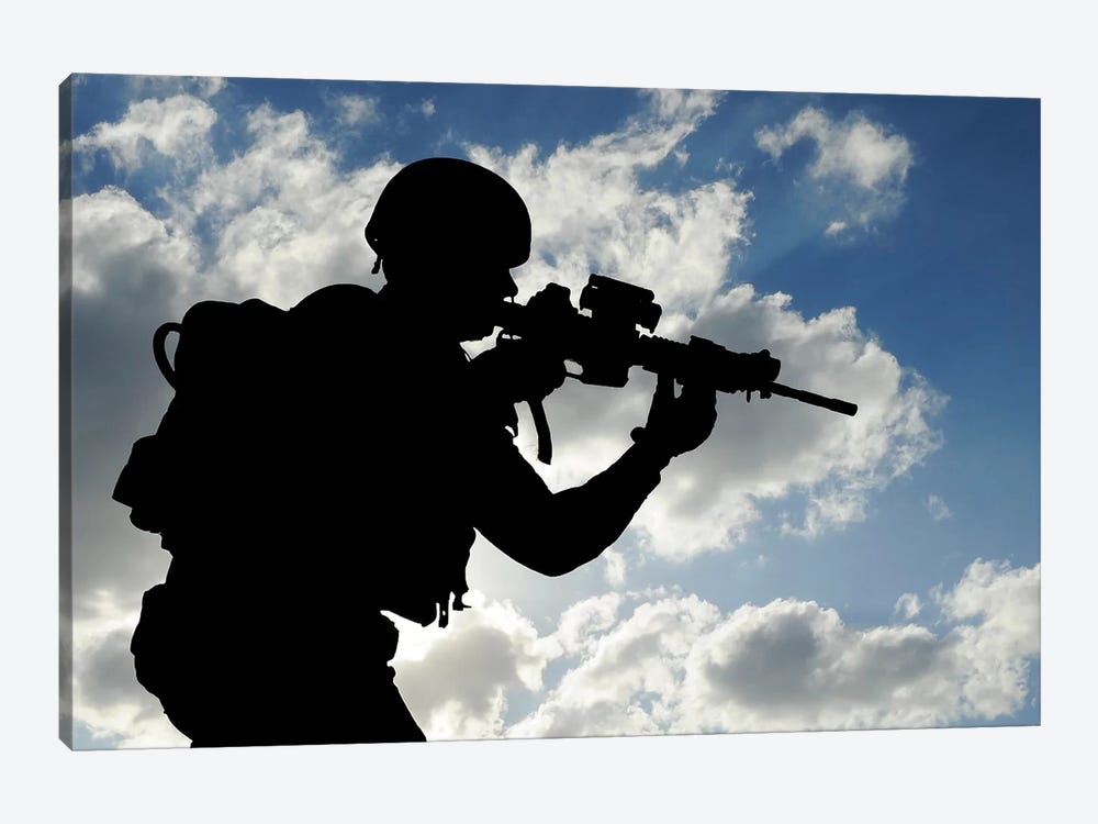 Silhouette Of A Soldier Against A Cloudy Sky by Stocktrek Images 1-piece Canvas Artwork
