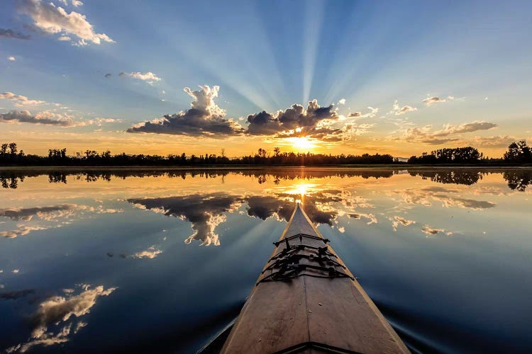 Kayaking into sunset rays on McWennger Slough, Kalispell, Montana, USA