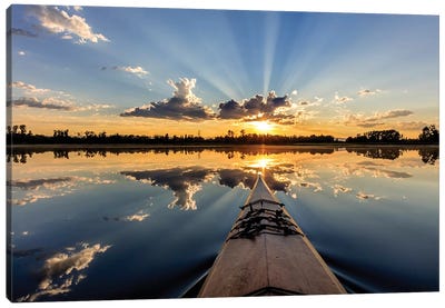 Kayaking into sunset rays on McWennger Slough, Kalispell, Montana, USA Canvas Art Print - Cloudy Sunset Art