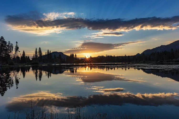 Sunrise clouds reflecting into Sprague Lake in Rocky Mountain National Park, Colorado, USA