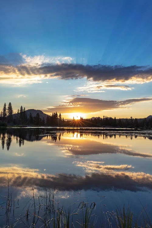 Sunrise clouds reflecting into Sprague Lake in Rocky Mountain National Park, Colorado, USA