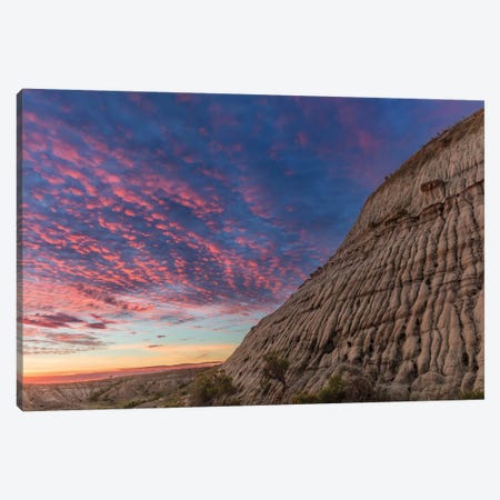 Vivid sunrise clouds over badlands formation in Theodore Roosevelt National Park, North Dakota, USA Canvas Print #UCK94} by Chuck Haney Canvas Wall Art