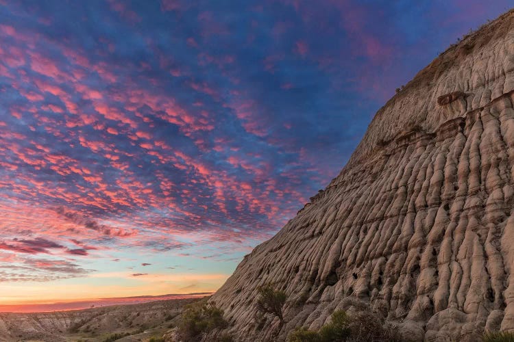 Vivid sunrise clouds over badlands formation in Theodore Roosevelt National Park, North Dakota, USA