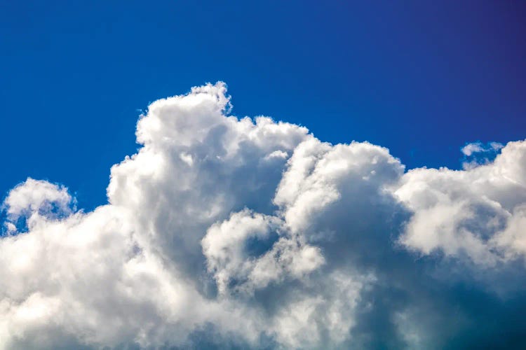 Gloomy dramatic cloudy blue sky background with fleecy curly soft white clouds.